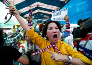 Crowd with woman in foreground in yellow with raised arm