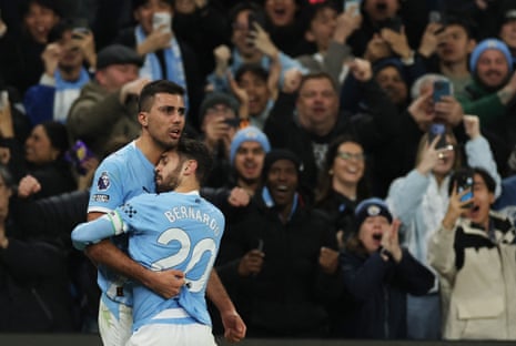 Rodri has a cuddle with Bernardo Silva.