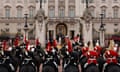 Military horses and their riders stand outside Buckingham Palace for trooping the colour