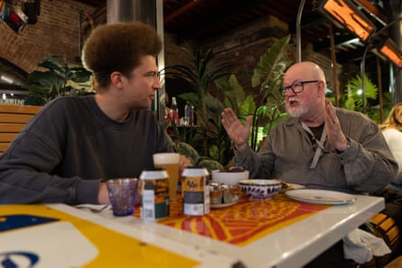 Alex and Mike chatting across a restaurant table