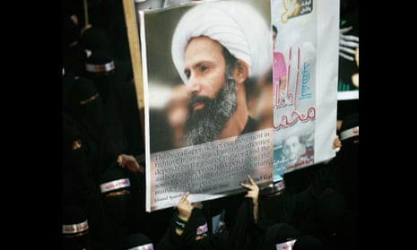 A Saudi anti-government protester carries a poster with the image of jailed Shia cleric Sheik Nimr al-Nimr. 