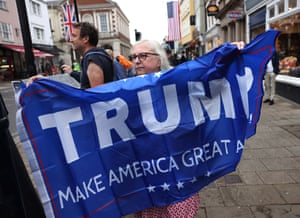 A supporter of Donald Trump holds a flag