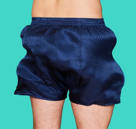 A man wearing billowing blue boxer shorts