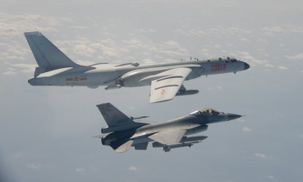 A Chinese H-6 bomber (top) flying over the Bashi Channel near Taiwan as a Taiwanese F-16 (bottom) approaches.