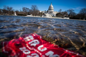 A campaign sign for Donald Trump lies underwater in the Capitol meditation pool, near the western front of the U.S. Capitol on Saturday.