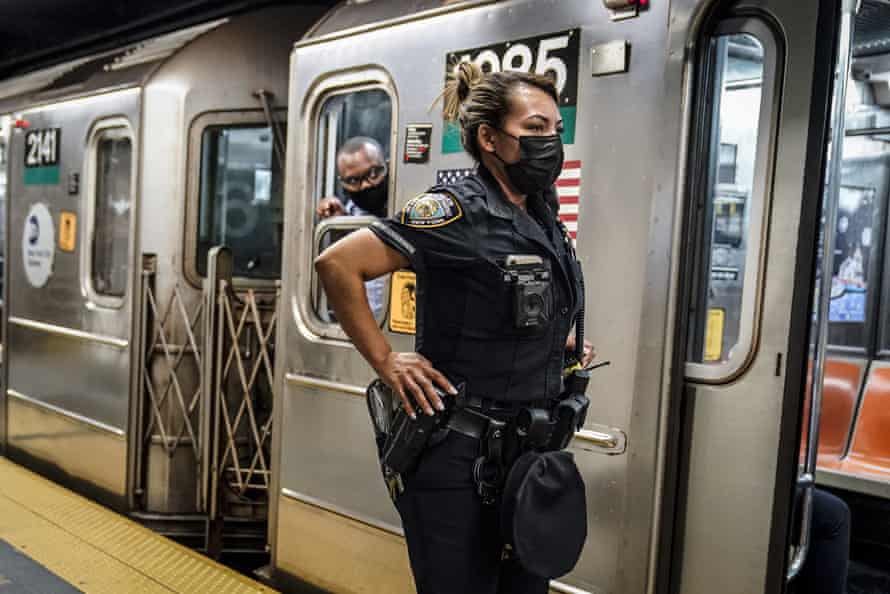 A New York officer and a subway conductor inspect the subway platform at the Grand Central Terminal station.
