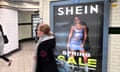 a woman walks past an advertisement for Shein in London