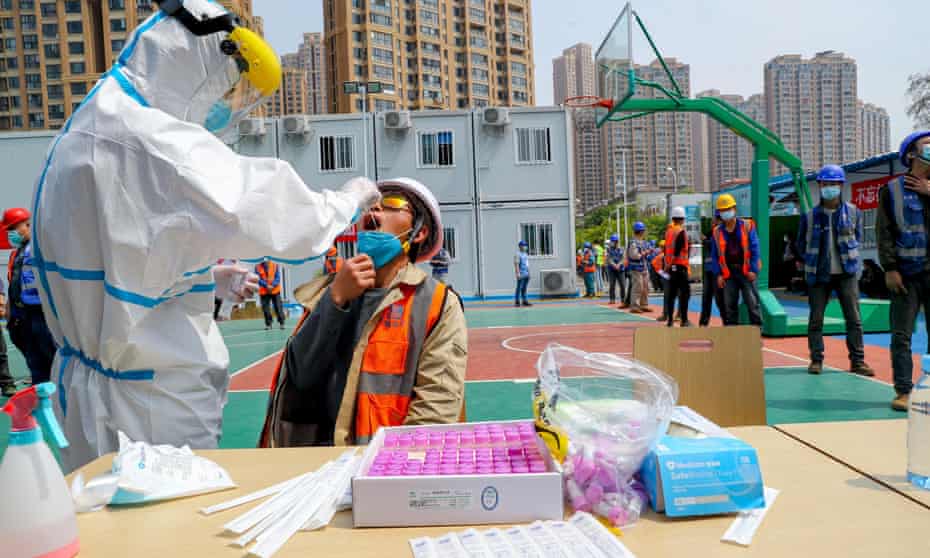 Construction workers are tested for coronavirus in Wuhan, China, 7 April 2020