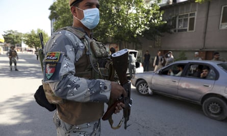 Afghan security personnel search cars at a checkpoint around the Green Zone, which houses embassies, in Kabul