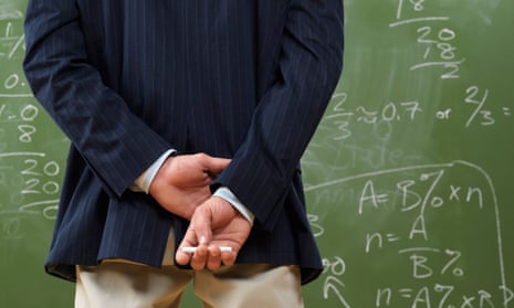 A teacher in front of a blackboard.