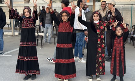 Palestinians wait for relatives freed from Israeli prisons in the Hamas-Israel hostage swap