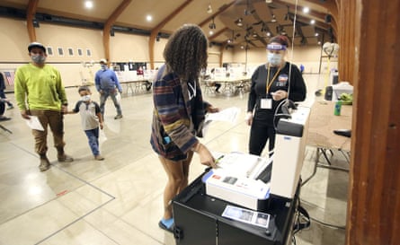 Taylor Wilson, a first-time voter, casts her ballot at the Nevada county fairgrounds center in Grass Valley, California.