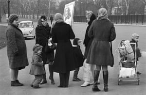 A demonstrator engages with passers-by