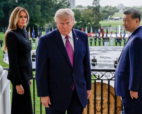 President Donald Trump, first lady Melania Trump and the Chinese president, Xi Jinping, react after watching a military demonstration at the White House