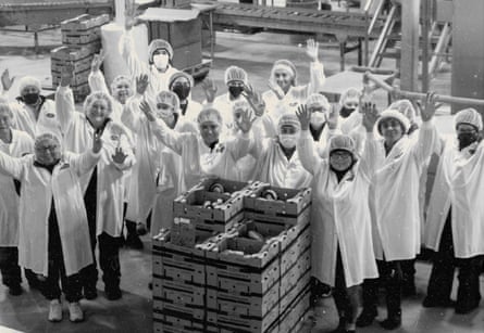 Workers in white coats and hair nets