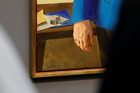 closeup of Merkel’s hand in the portrait and items in the background