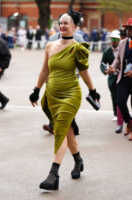 A racegoer arrives for Champions Day at Ascot.