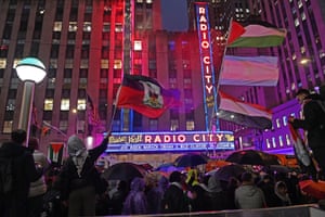 Supporters of Palestinians wave flags outside Radio City Music Hall