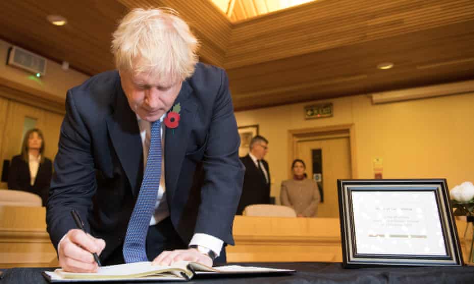 Boris Johnson signs a book of condolence for the Essex lorry victims