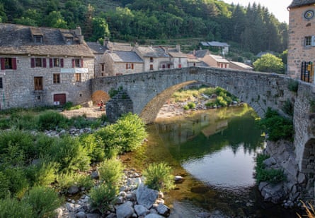 An old stone bridge spans a river at Le Pont de Montvert