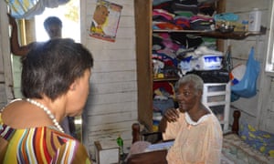 Patricia Scotland speaks to a local resident in Dominica.