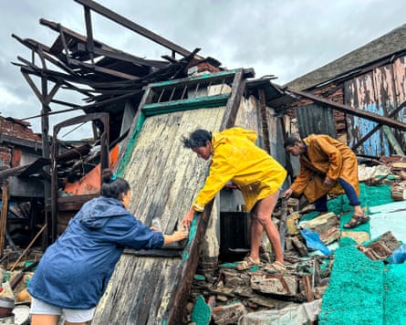 Collective effort … a family salvages belongings from the rubble of their home in Santiago de Cuba, Cuba.