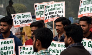 Indian activists hold placards during a mask distribution drive at the roadside in Delhi on Thursday.