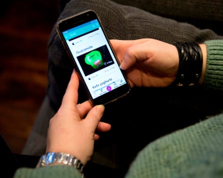 A woman uses the Olio mobile app to look for food to swap with other users