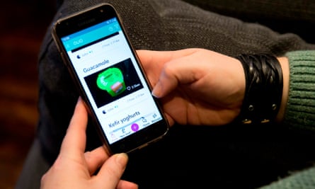 A woman uses the Olio mobile app.