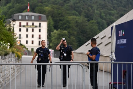 Police officers walk out of a hotel complex in Switzerland where talks are taking place.