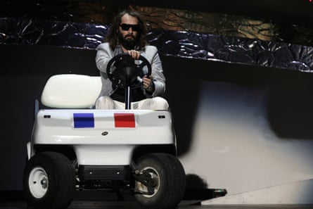 Sébastien Tellier on a white golf cart with a French flag logo on the front.
