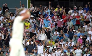 The Barmy Army and England’s Stuart Broad celebrates after Australia’s David Warner lost his wicket.