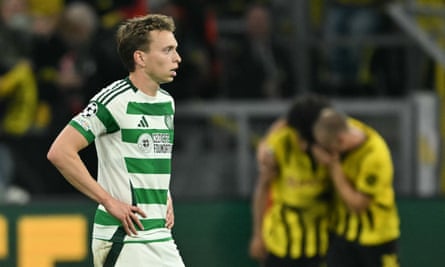 Celtic’s Alistair Johnston looks on as Dortmund celebrate