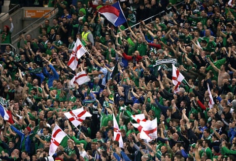 Northern Ireland fans celebrate the victory at Windsor Park.