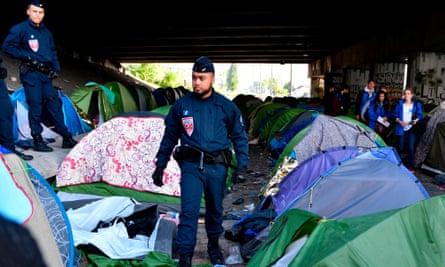 French riot police at a cleared migrant camp in Paris