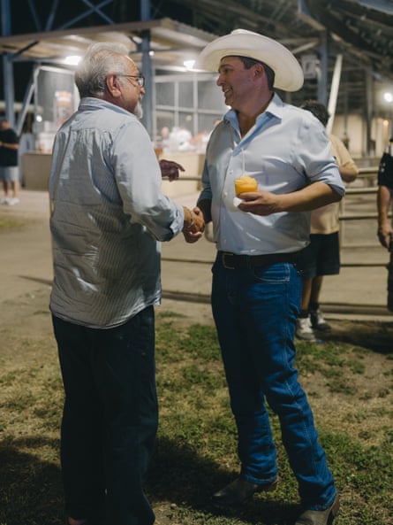 Two men shake hands