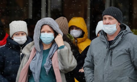 People wearing protective face masks walk along the Nevsky Prospekt in St Petersburg. Russia reported a record 52,212 new Covid-19 cases in the last day.