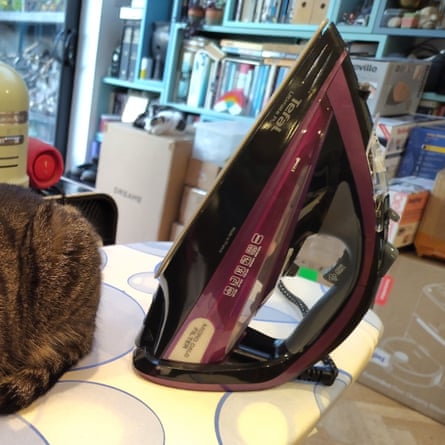 Tefal Ultimate Pure on an ironing board next to the back end of a cat