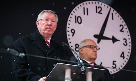 Sir Alex Ferguson gives a reading in front of a clock displaying the time of the crash.