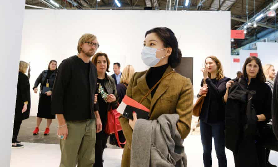 A woman wears a face mask while visiting the Armory Show in New York last month.