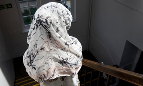 A young Iraqi Yazidi woman who suffered abuse by Isis captors, wearing a headscarf to protect her anonymity