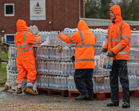 Men in hi-vis jackets unload crates of bottled water after an outage in Tunbridge Wells
