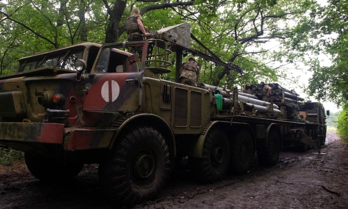 Ukrainian servicemen load a Bureviy multiple launch rocket system at a position in Kharkiv