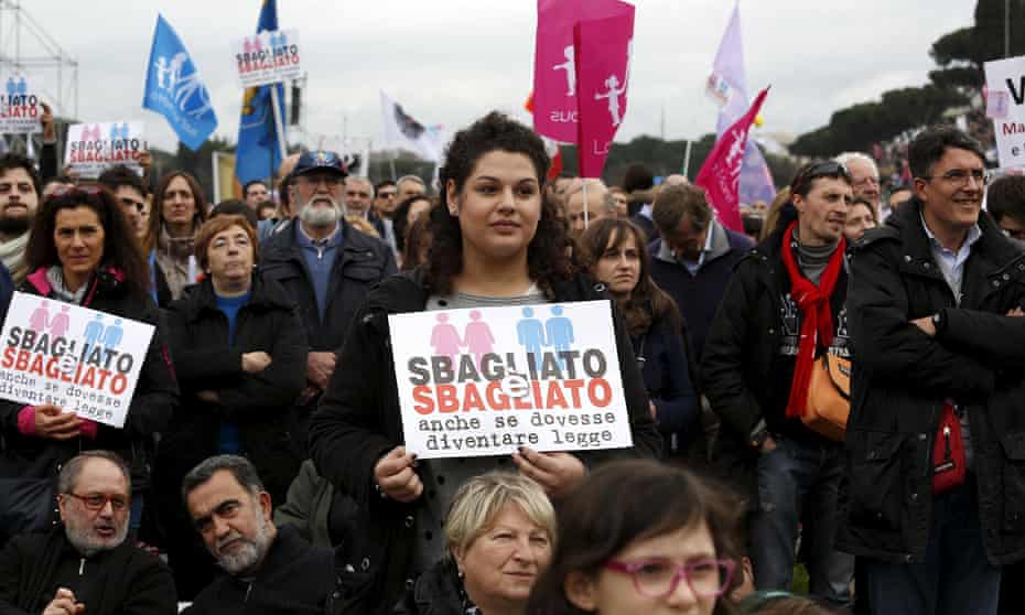 Protesters hold signs saying that same sex-marriage would be wrong even it was made legal in Italy.