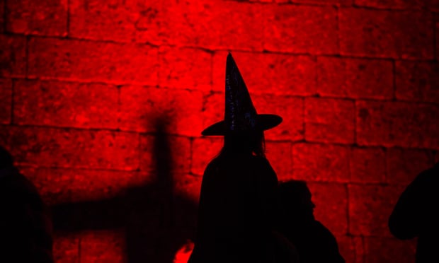 Silhouette of a person dressed as a witch