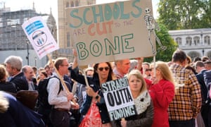 Headteachers march through Westminster to protest against funding cuts.