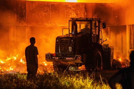 Heavy machinery is used to fight the fire that destroyed the national parliament