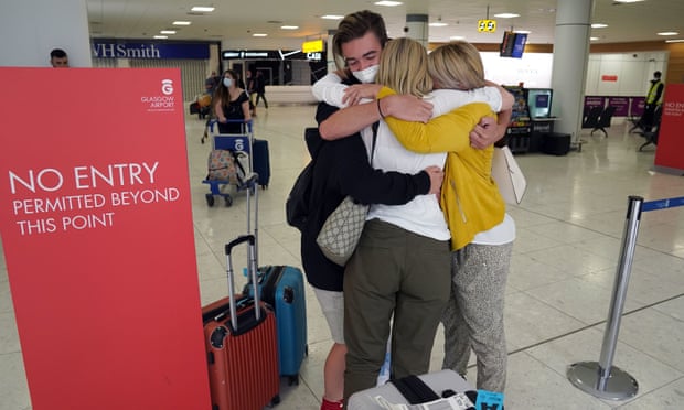 Michelle Bolger (right) with her two sons after arriving at Glasgow airport hugs her sister (back to camera).