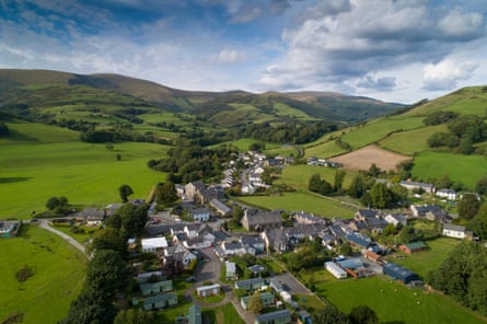 Village, green fields and mountains from the air