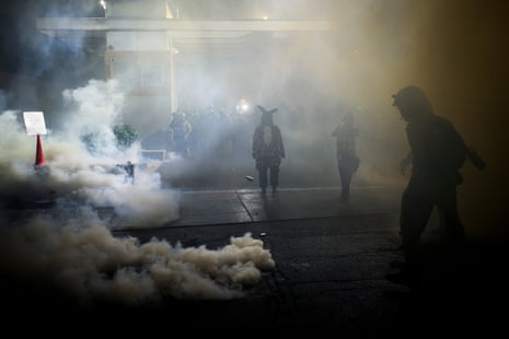 People walk through smoke